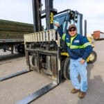 Treated Lumber Products | BB&S Lumber Worker with arm resting on forklift | BB&S Lumber