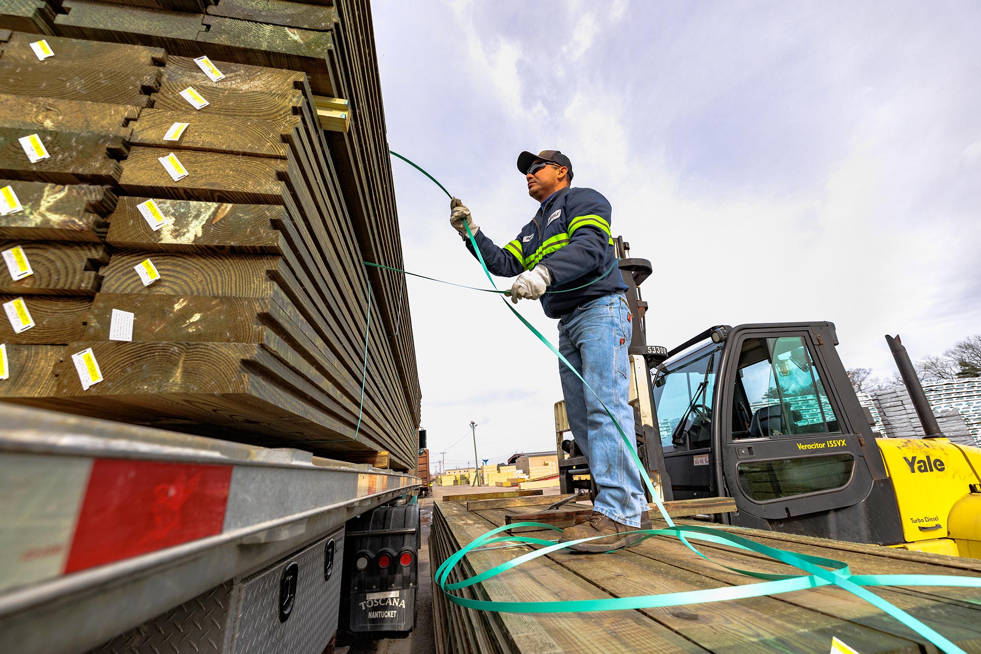 Treated Lumber Products | BB&S Lumber worker securing treated lumber on train | BB&S Lumber