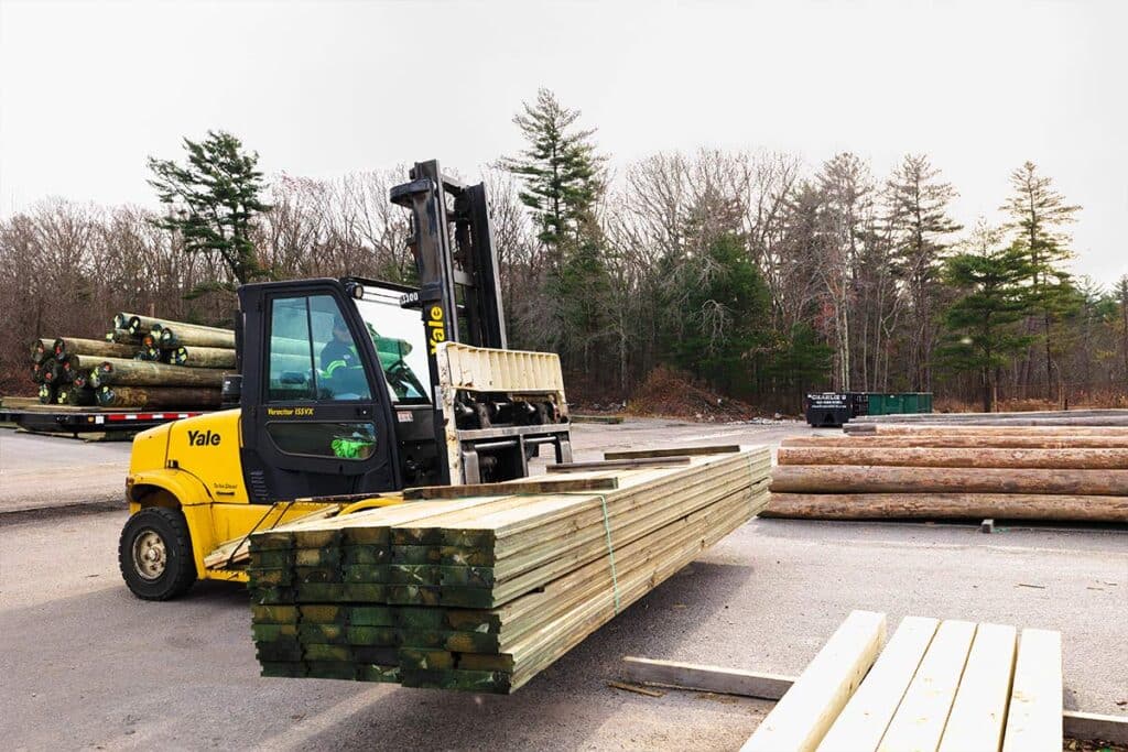 Treated Lumber Products | BB&S Lumber Forklift lifting pile of lumber | BB&S Lumber
